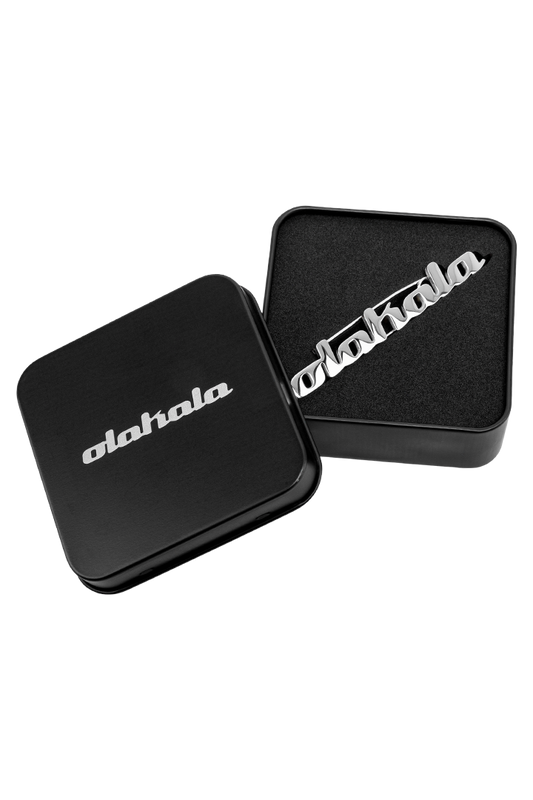 OLAKALA Pin in schwarzer Box mit silbernem Text und Logo, präsentiert im Offizieller OLAKALA® Onlineshop.