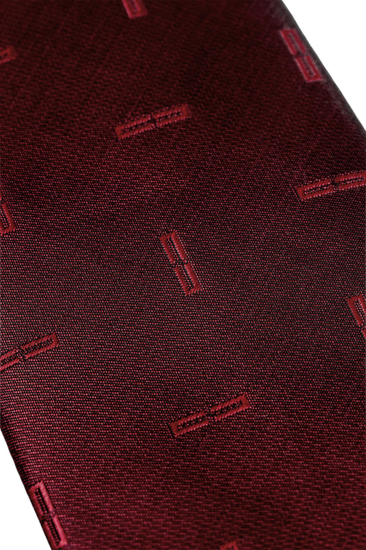 Monogram Tie Bordeaux: Close-up of a deep burgundy fabric with rectangular patterns, ideal for unisex style.