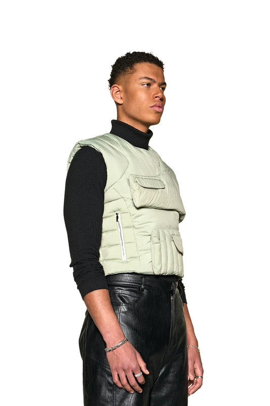 Men wear the Anatomy Puffer Vest with an asymmetrical cut and Velcro fastening, visible zipper and flap pockets and the embroidered OLAKALA logo.