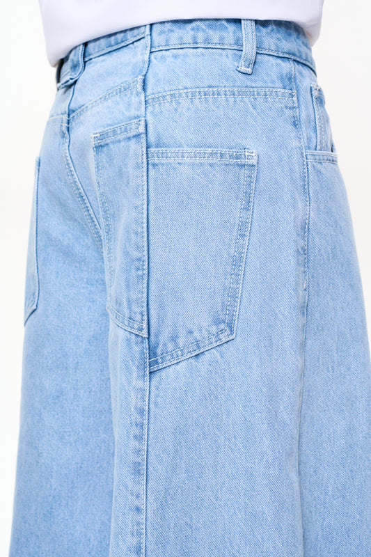 Close-up of the CC Blue Denim Pants Baggy with offset side seam and 5-pocket design, loose cut and embossed OLAKALA patch. Unisex jeans made from 14 oz denim.
