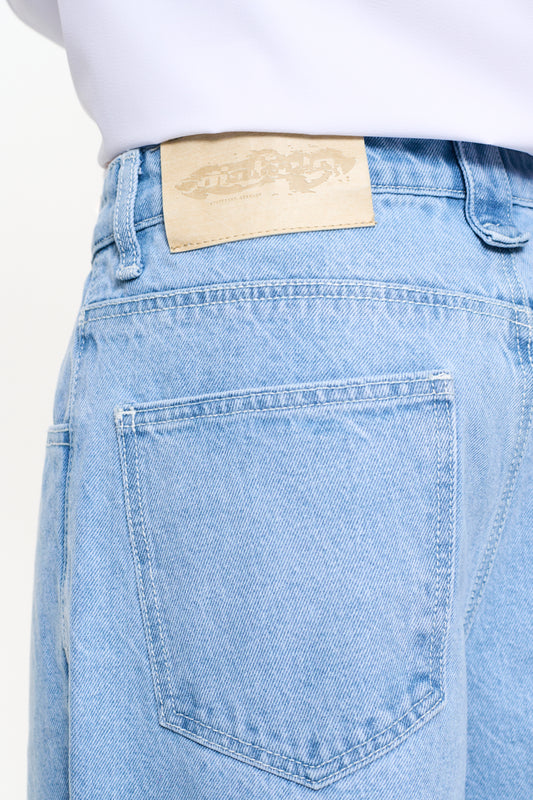 Person wears CC Blue Denim Pants Baggy with offset waistband, 5 pockets,
