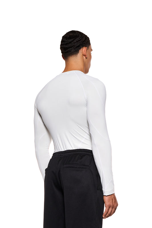 A man wears the Sports Anatomy Tech Top Gray with decorative stitching and OLAKALA Sports logo on the chest; tight-fitting unisex design.