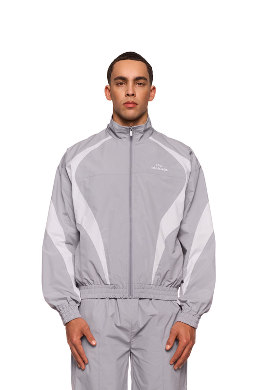 Man wears gray sports track jacket with embroidered OLAKALA Sports logo, elastic cuffs and breathable mesh lining for comfort.