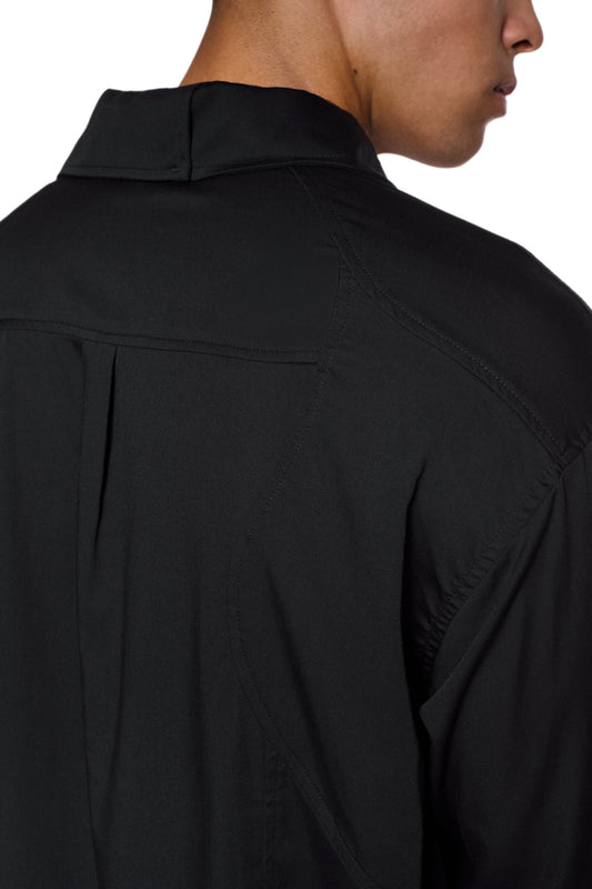 Back view of the CC Anatomy Shirt Black with double-layer collar, dividing seams and embroidered OLAKALA logo on the breast pocket.