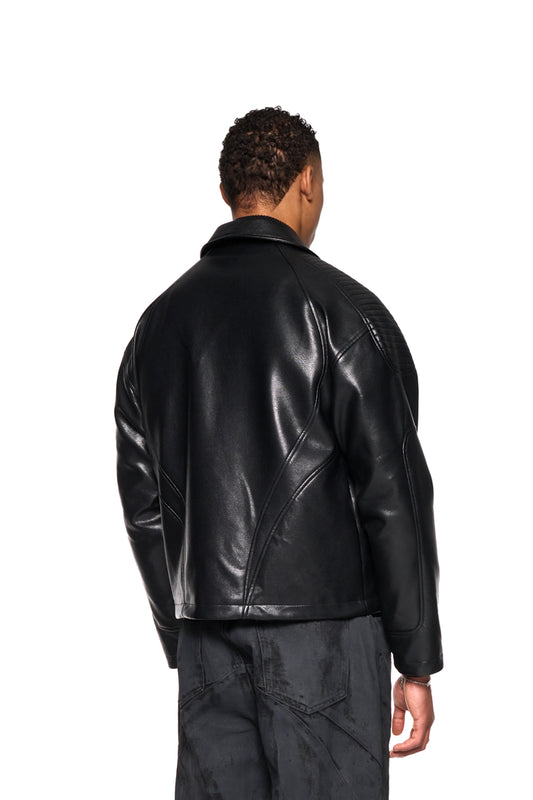 Man wears CI Leather Jacket Black with padded shoulders, front zipper, dividing seams and monogram lining. Vegan leather, oversized fit, unisex design.