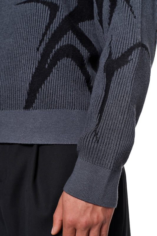 Person wears Luminous Sweater Gray with knitted pattern and elastic cuffs, loose fit, unisex, available in the official OLAKALA® online store.