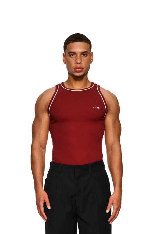 Mann im roten Contrast Tanktop Burgundy zeigt gesticktes OLAKALA-Icon auf der Brust, mit elastischem Ripp-Stoff und kontrastfarbenen Paspeln.