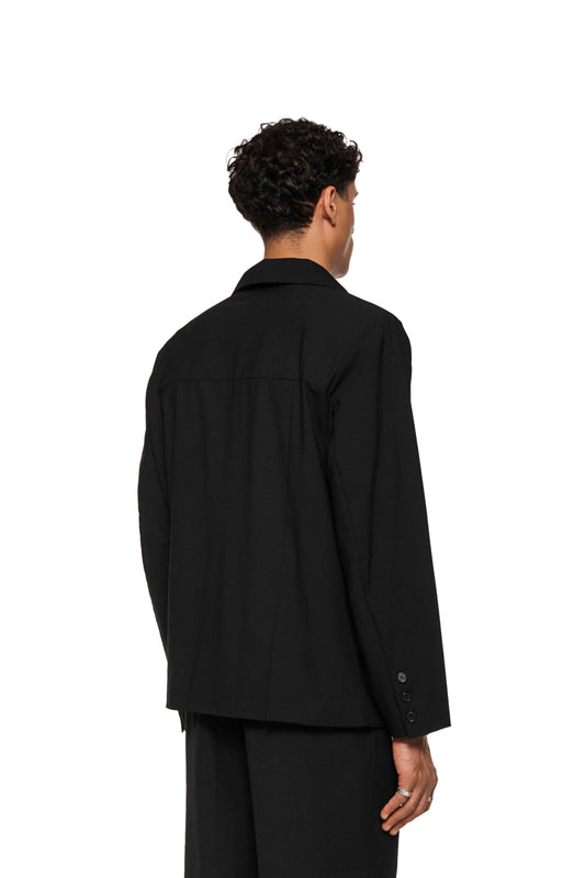 Unisex layered blazer with an asymmetric cut, double left side, removable shoulder padding, asymmetric lapel collar and several flap pockets.