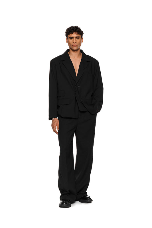 Unisex layered blazer with an asymmetric cut, double-layered left side, removable shoulder padding, multiple pockets and a loose fit.