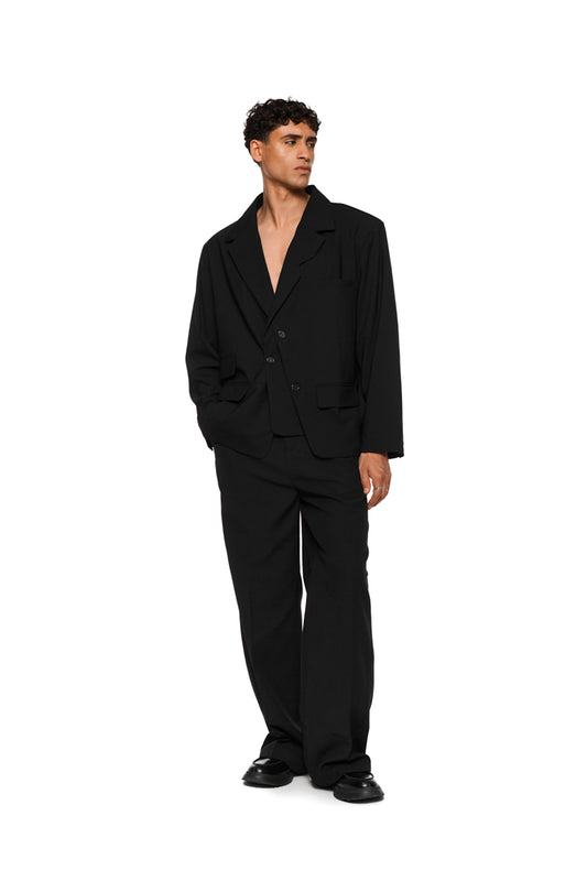 Asymmetric layered blazer with double layered left side, removable shoulder padding, multiple pockets and loose unisex cut, matching the OLAKALA® style.