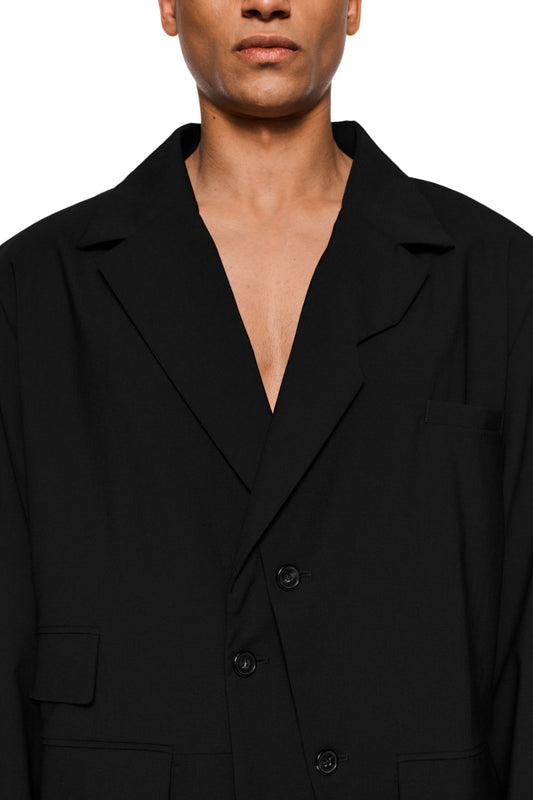Asymmetric layered blazer with double-layered side, removable shoulder padding, welt pocket and flap pockets, loose unisex cut and offset back vent.