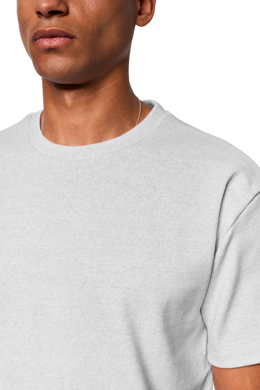Person wears Exquisite Rib T-Shirt Gray Melange with loose fit and thin necklace, focus on top made of solid rib fabric.