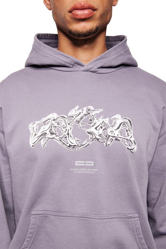 Person wearing Greyzone Hoodie Lilac with abstract liquid metal design and GLAKLA © 2024 GREYZONES lettering, hood and kangaroo pocket visible.