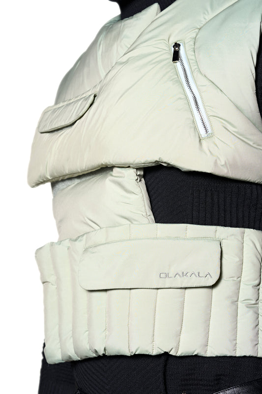 Close-up of the Anatomy Puffer Vest with asymmetrical cut, 3M filling material, zippered pockets and embroidered OLAKALA logo on the front.