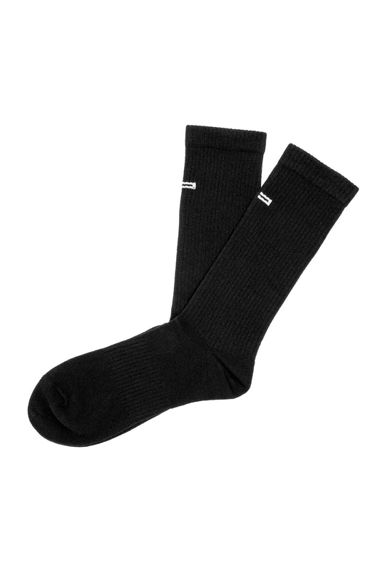 Black crew socks with ribbed knit pattern, white stripe and embroidered OLAKALA logo on the front. Linen Socks Black in a pack of 2.