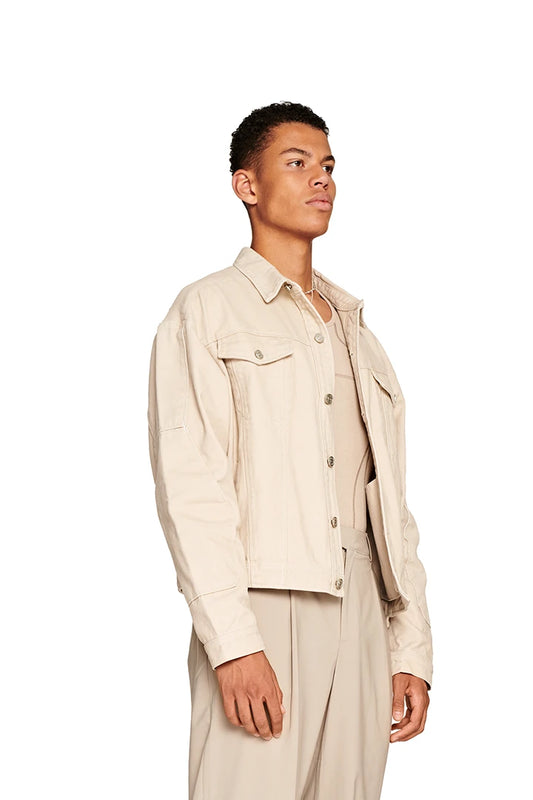 Man wears Elusive Denim Jacket with oversize fit, two breast pockets and embroidered E logo.