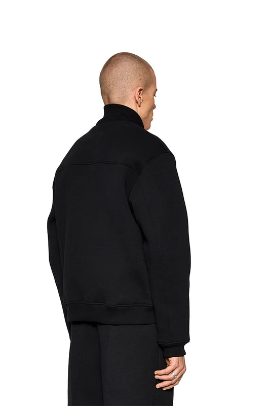 Man wears Substance Sweatjacket Black with ribbed collar and cuffs, zippered pockets, OLAKALA silicone patch on chest, regular fit.