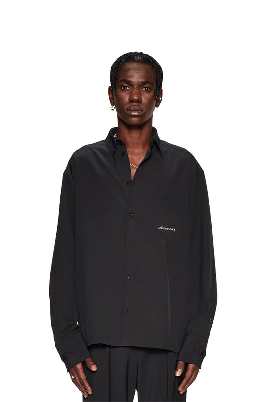 Man wearing CC Button Shirt Black with double collar and chest pocket, presents oversized unisex style by OLAKALA.