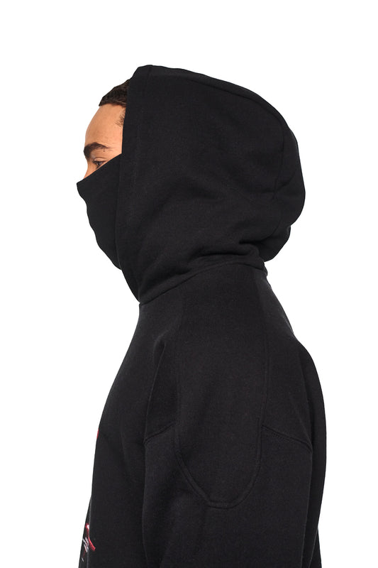 Person trägt Alien Intel Mask Hoodie mit Ripp-Bündchen und Siebdruck-Grafik, oversized und cropped, passend zu OLAKALA's unisex Streetwear-Kollektion.