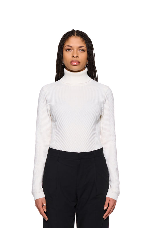 Frau in weißem Anatomy Turtleneck von OLAKALA, eng anliegend mit Rollkragen, modisch und vielseitig tragbar.