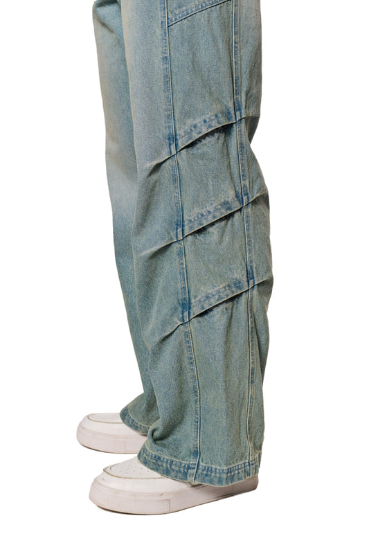 Gills Washed Denim Pants Blue with air inlets, 5-pocket design and OLAKALA logo, combined with white sneakers.