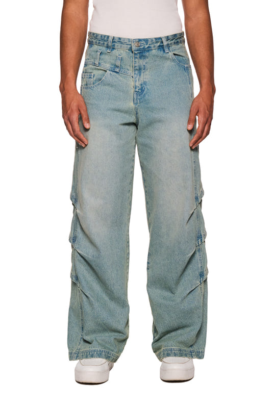 Person wears Gills Washed Denim Pants Blue with gill-look vents, 5-pocket design and OLAKALA logo on the front. Unisex, loose fit.