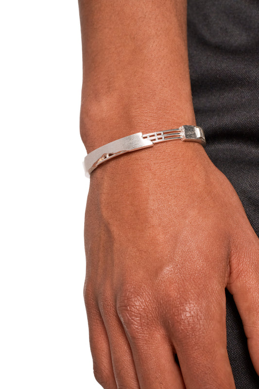 Close-up of a silver-plated brushed cuff bangle with a 