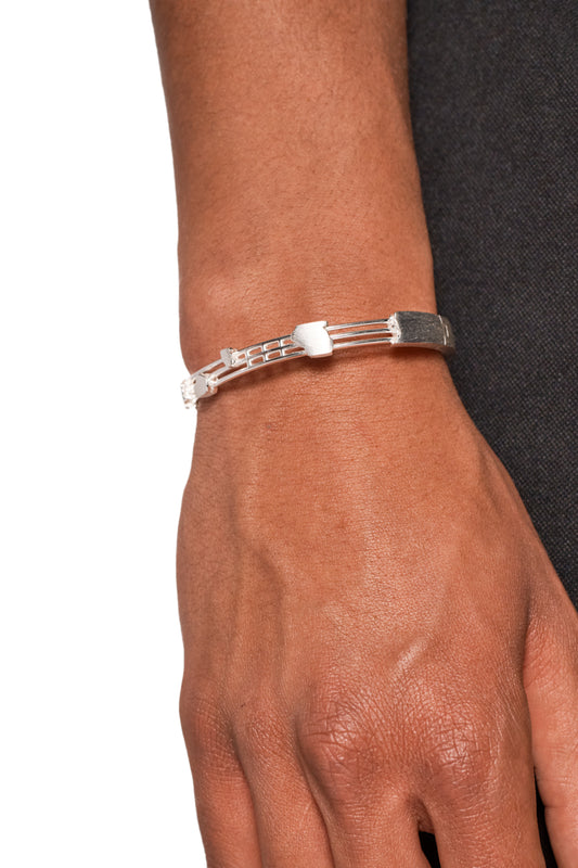 Close-up of a silver-plated bangle with a 