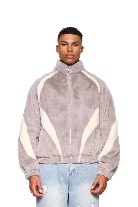 Mann trägt graue Two-Toned Fur Jacket mit Stehkragen und Reißverschluss, lockere Passform, Raglanärmel und Vorderseitentaschen.