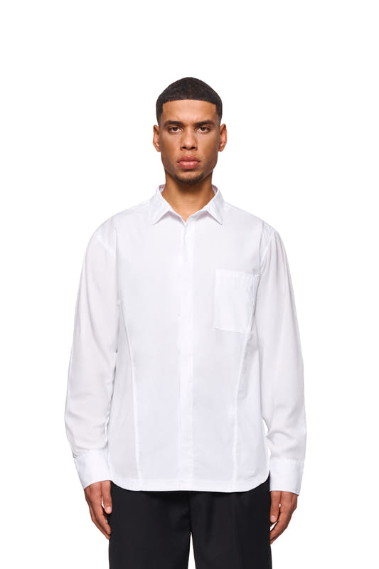 Man wears CC Core Button Shirt White with concealed placket and chest pocket, offers durability and comfort with durable blended fibers and reinforced collar.