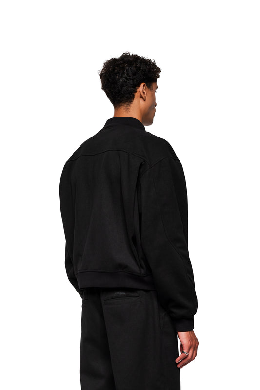 Person from behind in black Exquisite Bomber Jacket Black, loose cut, with breast pocket and darts, emphasized by modern cut and functionality.