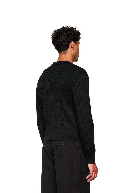 Back view of a model in the Exquisite Cable Knit Polo Black, with cable knit pattern, double collar and close-fitting cut, presents the shoulder and back fit.