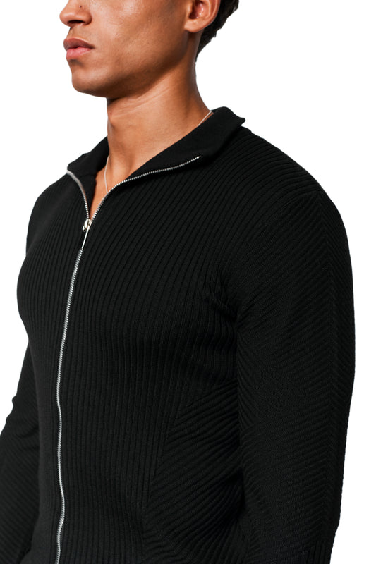Man wears Exquisite Knit Jacket Black, slim fit with anatomical knit pattern, silver zipper and stand-up collar.