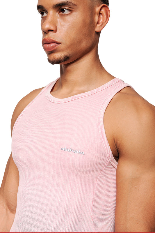 Close-up of the E.O.I Cotton Candy tank top with embroidered olahala. logo on the left chest, side dividing seams and a tight fit in a waffle knit pattern.