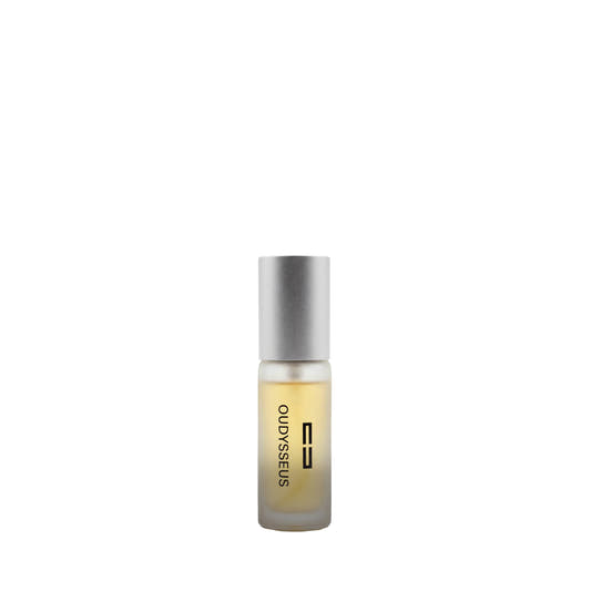 A small, matte silver bottle of Oudysseus Esprit de Parfum containing a yellowish liquid, known for its mystical notes of red berries, sandalwood, and leather.