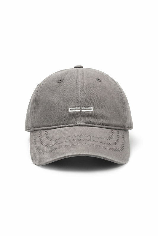 CC Icon Cap Dark Gray: A gray, unstructured baseball cap with a slightly curved brim and an embroidered OLAKALA logo on the front. Adjustable with a metal clip at the back.