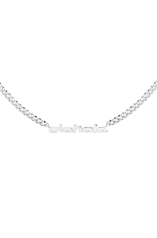Silver CC logo necklace with name pendant, 50 cm long Cuban link chain from OLAKALA, presented as a fashionable piece of jewelry.